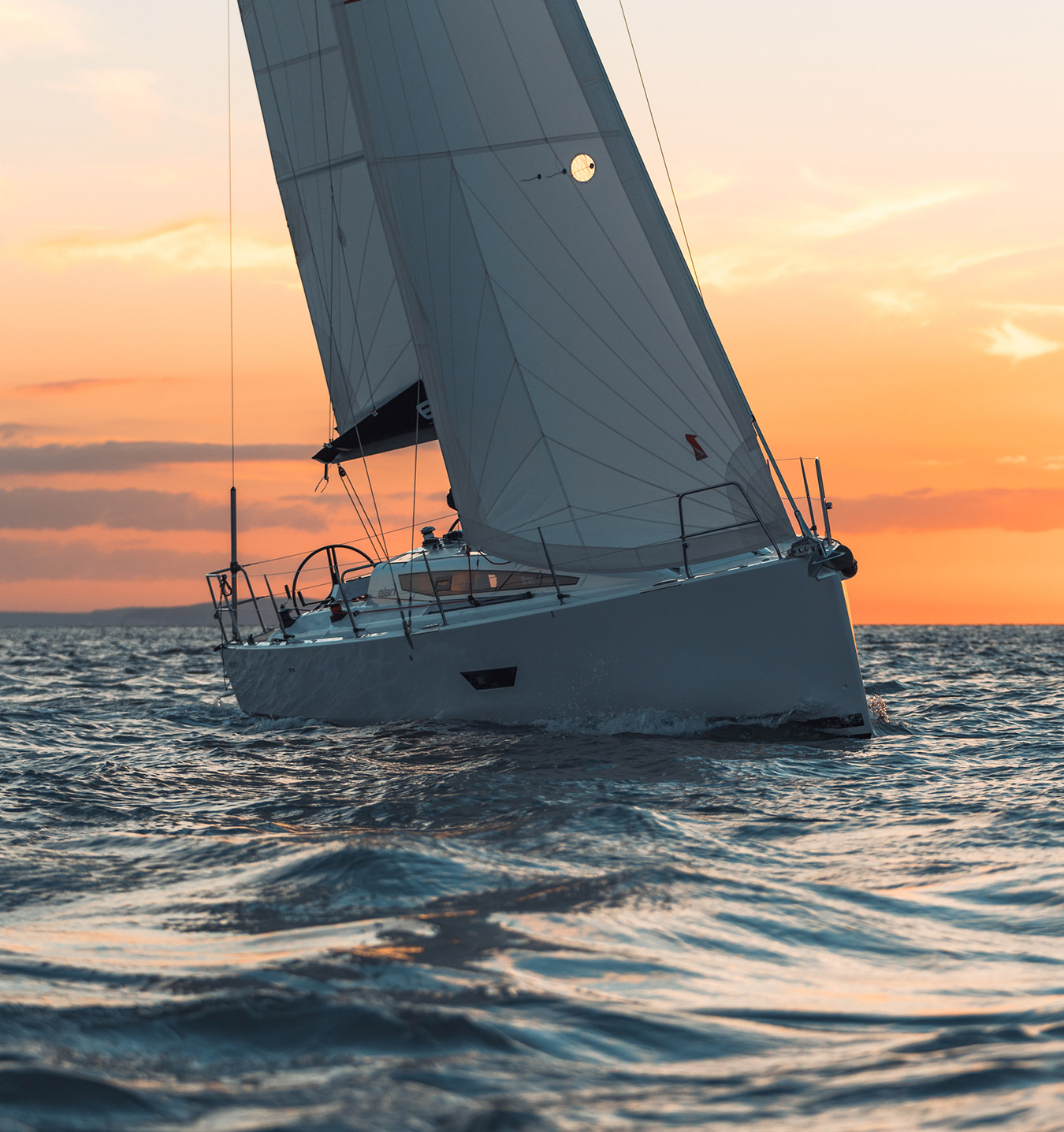 Elan E4 Sailing Upwind in sunset Performance Cruiser