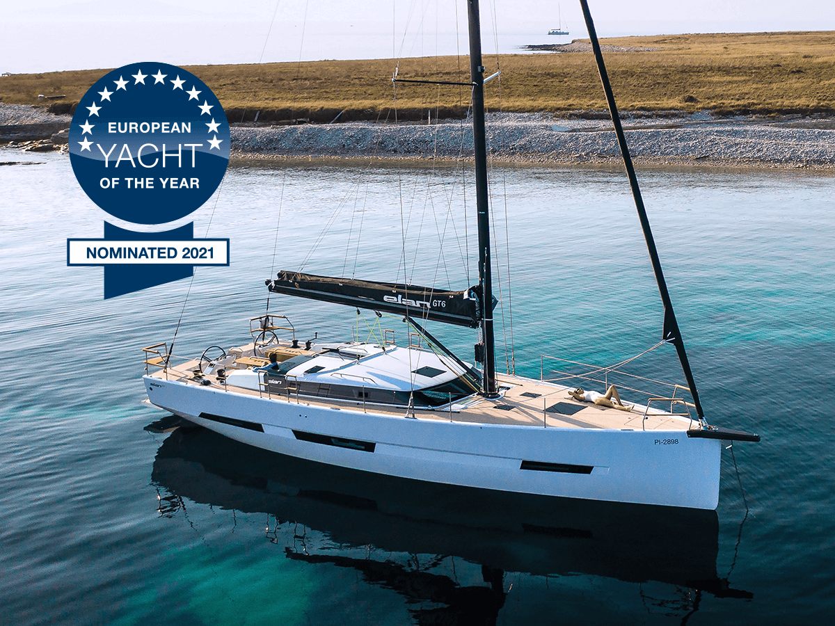 Elan Yachts Elan GT6 anchored over turquoise water, viewed from above and overlayed with European Yacht of the Year 2021 nominated logo